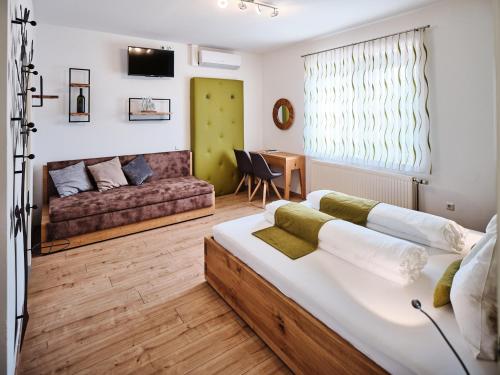 a living room with a bed and a couch at Weingut Gästehaus D&D Haider in Jois