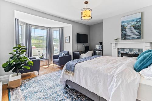 a bedroom with a bed and a living room at McKay Manor on Duckworth in St. John's