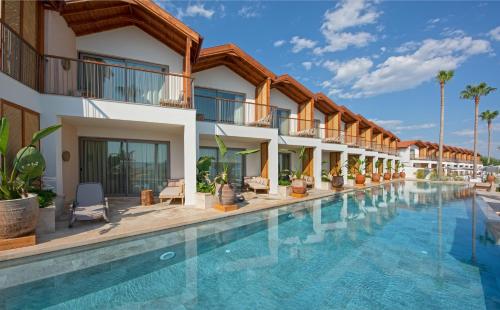 a hotel room with a pool and a balcony at Day One Beach Resort & SPA - Adult Only in Alanya