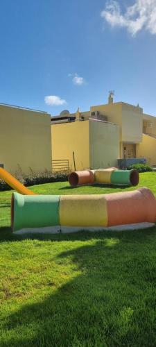 a group of inflatable objects sitting on the grass at Meia Praia Terrace in Lagos