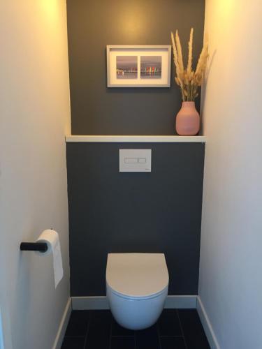 a bathroom with a toilet and a picture on the wall at Agréable maison neuve Angers Centre-Madeleine in Angers
