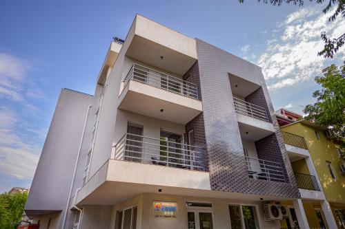 a white building with balconies on the side of it at Pensiunea CASID in Eforie Nord