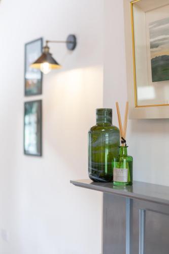 a shelf with two glass jars on a wall at Duneden Cottage and Grounds in Randalstown