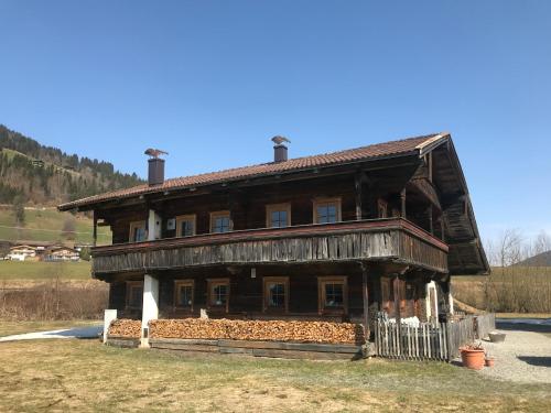 a large wooden house in a field at The Farm in Westendorf