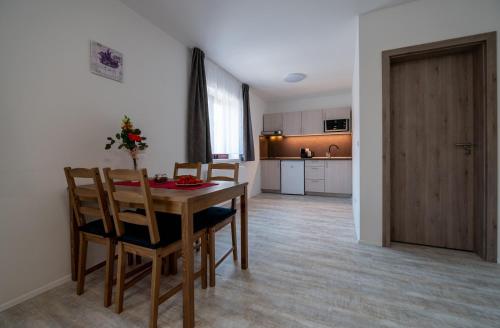 a kitchen and dining room with a table and chairs at Penzion Kamenný dvůr in Třeboň