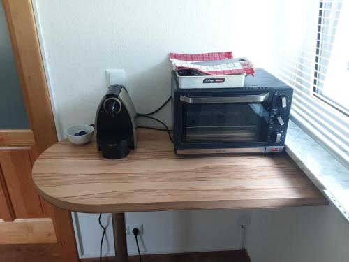 a toaster oven sitting on top of a table at Apartment-Ferienwohnung 3 Treffen am Ossiachersee in Treffen