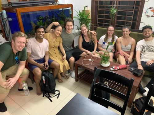 a group of people sitting in a living room at Cheerful Hoi An Hostel in Hoi An