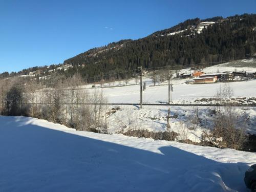 a snow covered field with a mountain in the background at The Farm in Westendorf