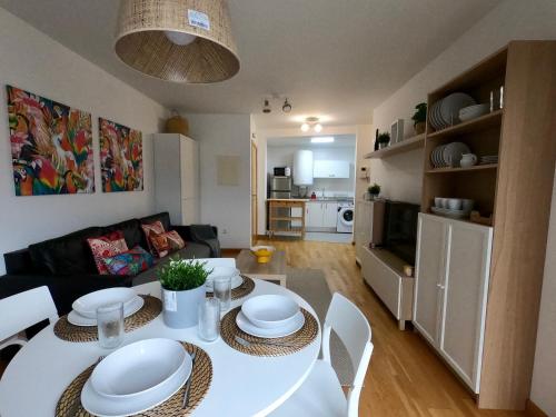 cocina y sala de estar con mesa blanca y sillas en Apartamento con balcón y vistas al mar en Viveiro