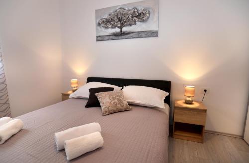 a bedroom with a large bed with two night stands at MiKa in Kaštela