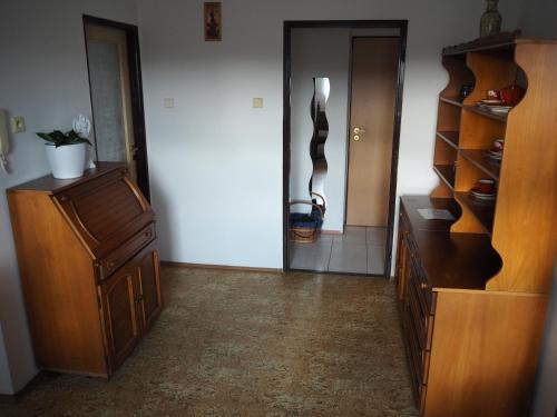 a living room with a wooden cabinet and a hallway at Ubytování u Josefa in Vodňany