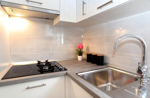 a kitchen with a sink and a stove at MiKa in Kaštela