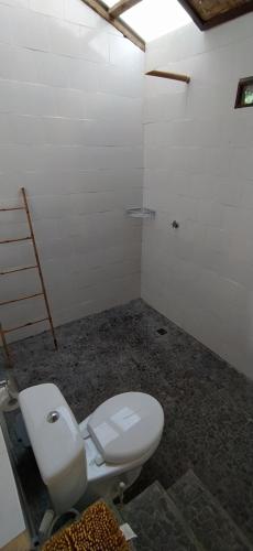 a bathroom with a toilet in a room at Moyo Island Resort in Moyo Island