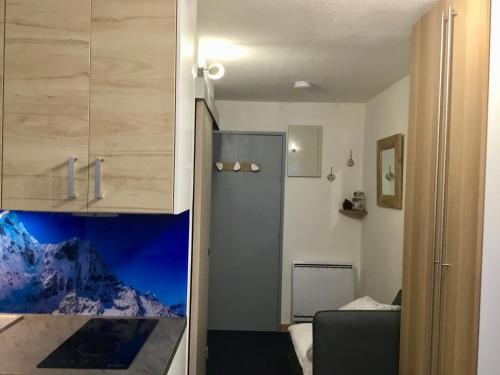 Cette chambre comprend une cuisine avec un comptoir et une armoire. dans l'établissement L'AnsloBoys Montagne L2, à Les Deux Alpes
