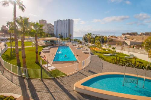 an overhead view of a swimming pool in a resort at Waves apartment - relax in Costa Blanca in Benidorm