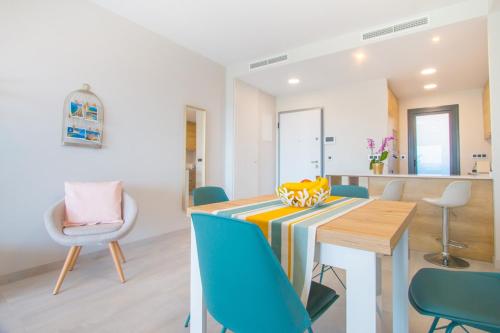 a kitchen and dining room with a table and chairs at Waves apartment - relax in Costa Blanca in Benidorm