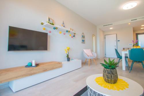 a living room with a flat screen tv on a wall at Waves apartment - relax in Costa Blanca in Benidorm