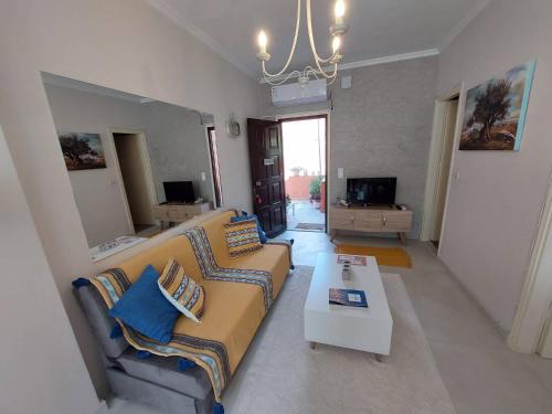 a living room with a couch and a coffee table at Anatoli Apartment in Perama