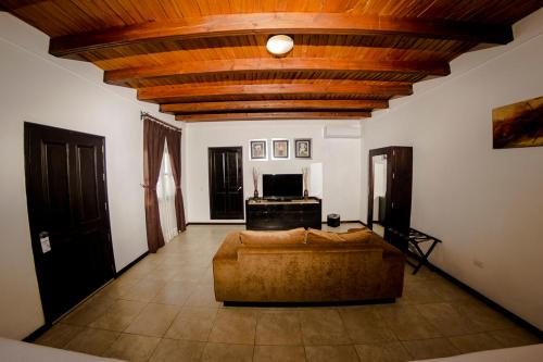 a living room with a couch and a wooden ceiling at Hotel Boutique Hacienda Guadalupe in San Miguel de Allende