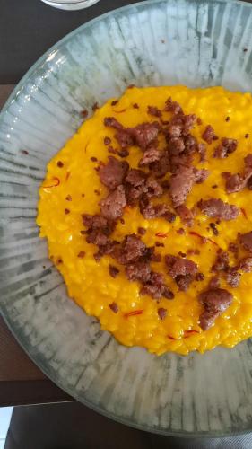 a bowl of food with bacon on top of it at Mercure Milano Agrate Brianza in Agrate Brianza