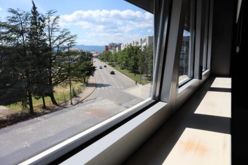 an open window with a view of a street at Something Different in Nikšić