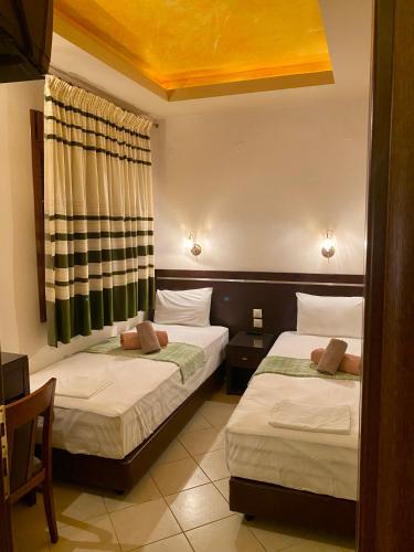 Ένα ή περισσότερα κρεβάτια σε δωμάτιο στο Hotel Alkionis
