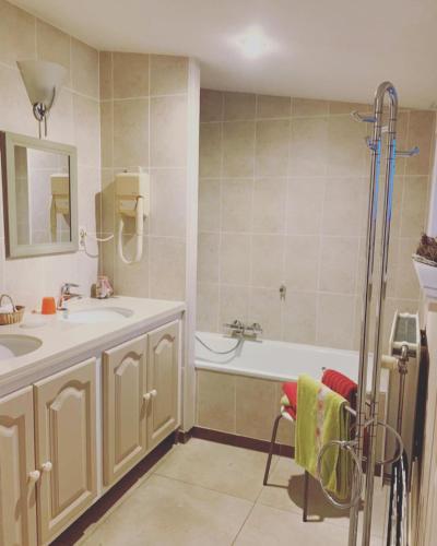 a bathroom with a tub and a sink and a bath tub at Hove Ter Hille in Jabbeke