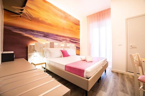 a bedroom with a bed and a painting on the wall at Hotel Majorca in Gabicce Mare