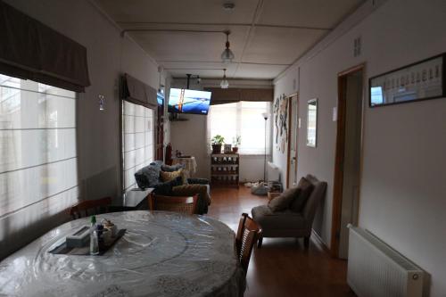 a room with a table and chairs and a living room at Aska Patagonia in Punta Arenas