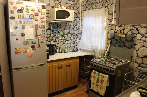 a kitchen with a refrigerator and a stove at Aska Patagonia in Punta Arenas