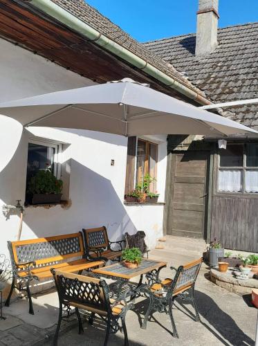 a patio with a table and an umbrella at Ubytování U Pavly in Borovany