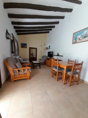 a living room with a couch and a table at Can Beia Rural House Ibiza in Nuestra Señora de Jesus