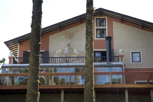 a house with a painting on the side of it at Villa Casato Residenza Boutique in Campos do Jordão