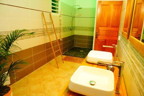 a bathroom with a toilet and a sink and a shower at TI COIN RELAX bungalow vue mer piscine privée in Saint-François