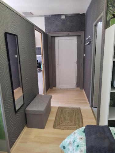 a room with a bed and a door and a rug at Studio indépendant accès direct autonome. in Le Cateau