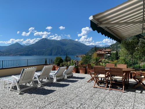 a row of chairs and tables on a patio at Il terrazzo sul Lago in Varenna