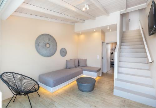 a room with a bed and a stair case at Blue Bay Resort Village in Batsi