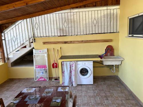 a laundry room with a washing machine and a staircase at Casanostra in San Vito Chietino
