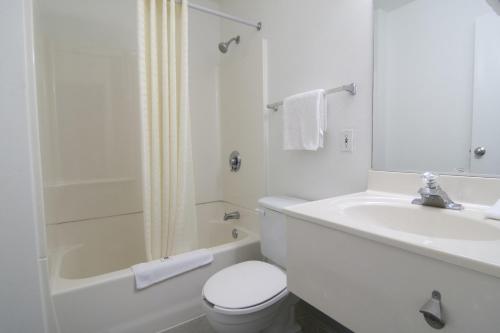 a white bathroom with a toilet and a sink at Motel 6-Lakeville, MN - South - Lakeville in Lakeville