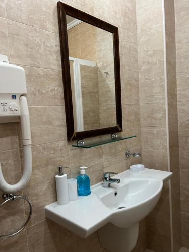 a bathroom with a sink and a mirror at Santa Marina Apartment 503 in Sozopol