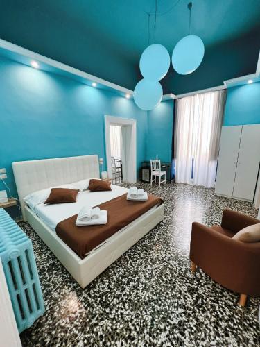 a bedroom with a large bed and blue walls at DEAS B&B in Trani