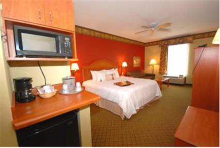 a hotel room with a bed and a microwave at Hampton Inn Laplace in Laplace