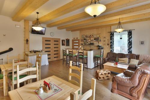 a living room with a couch and a table at Penzion Bobešova bouda in Železná Ruda