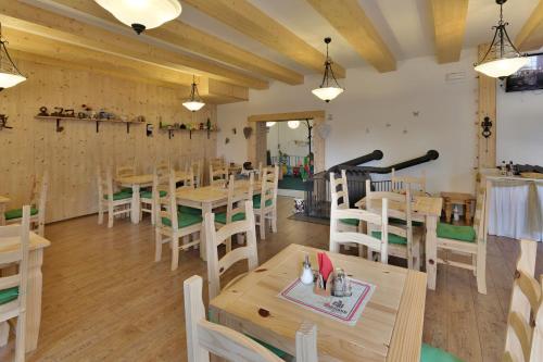 a dining room with wooden tables and chairs at Penzion Bobešova bouda in Železná Ruda