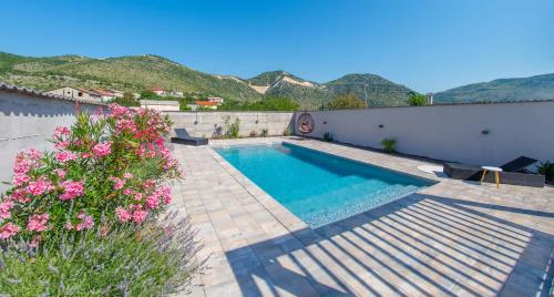 a swimming pool with mountains in the background at Villa Carpe Diem - with private pool in Mostar