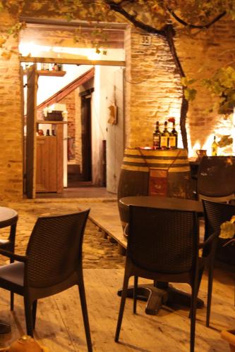 a restaurant with chairs and a table and a bar at La Neviera Nel Pozzo in Offida