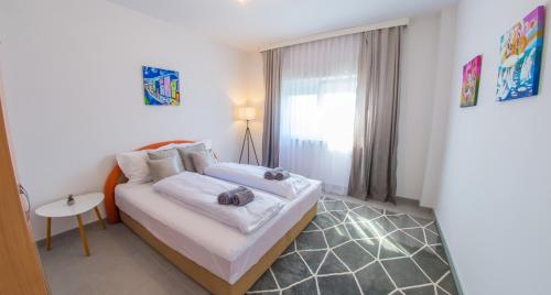 a bedroom with a bed and a table and a window at Villa Carpe Diem - with private pool in Mostar