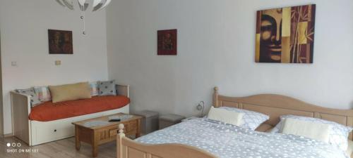 a small bedroom with two beds and a table at Apartmán Extoll in Třeboň
