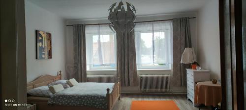 a small bedroom with a bed and a window at Apartmán Extoll in Třeboň