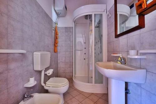 a bathroom with a toilet and a sink and a shower at Masseria Bianca in Taurisano